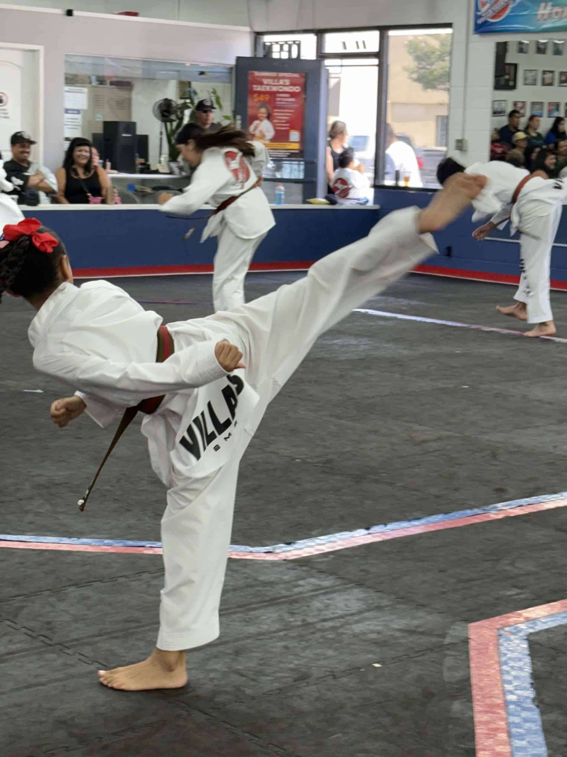 Villa's Taekwondo student practicing kicks during class in Los Angeles