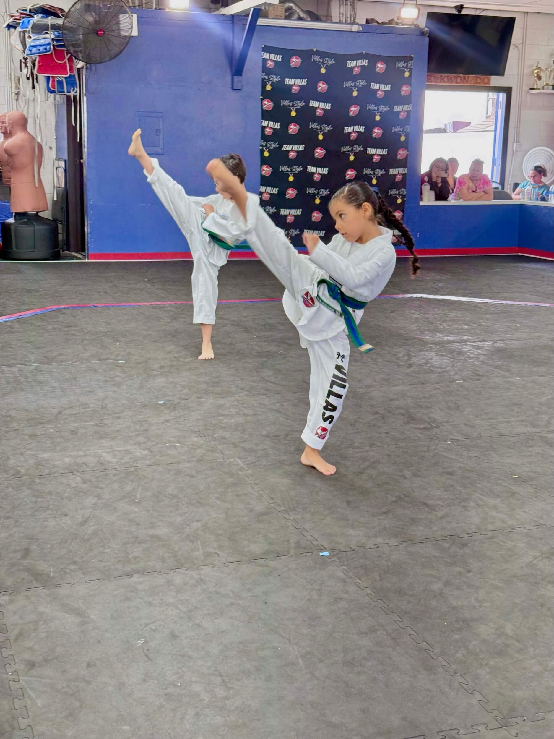 Villa's Taekwondo students practicing kicks during class in Los Angeles