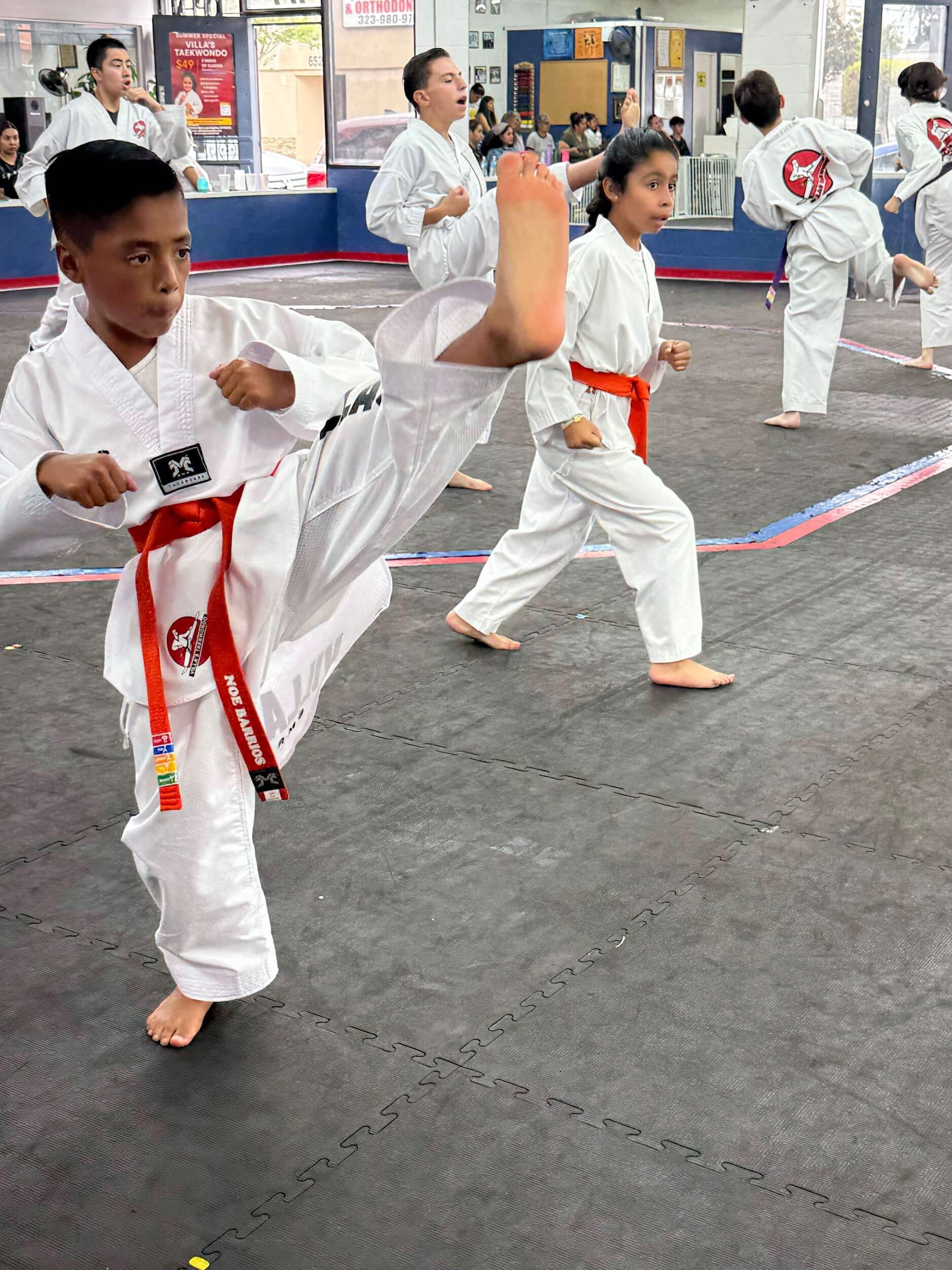 Villa's Taekwondo student practicing kicks during class in Los Angeles